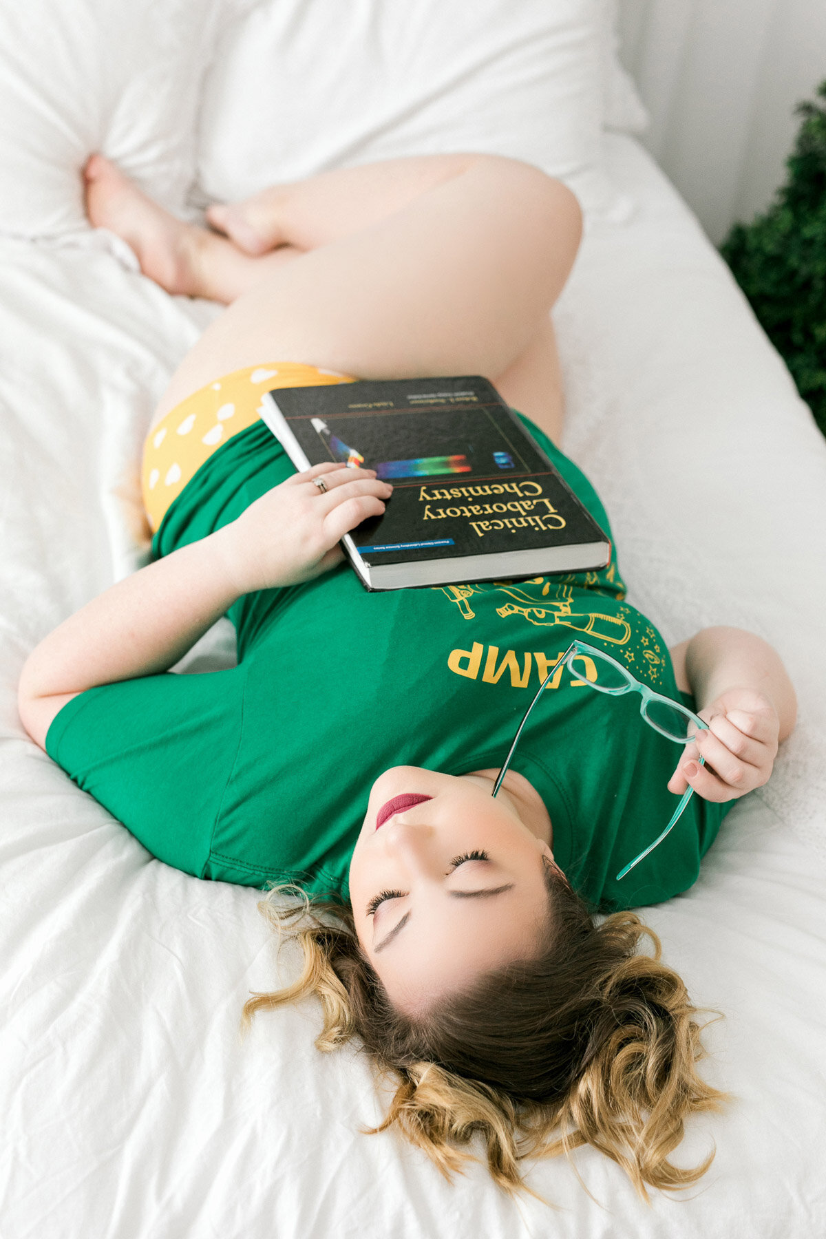 woman wearing stranger things shirt and chemistry booked on bed