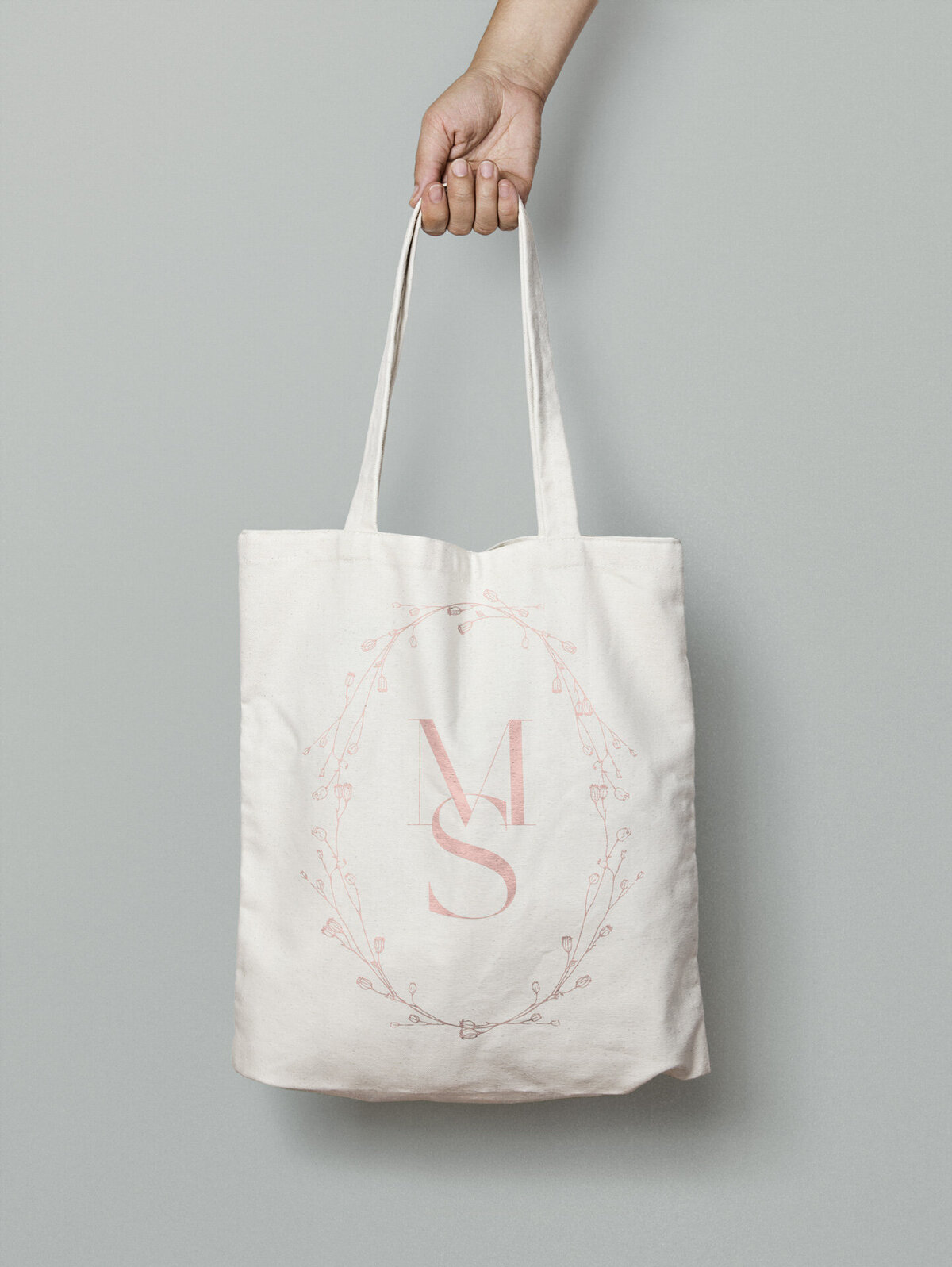 a mockup showing. a pink stamp logo on a tote bag