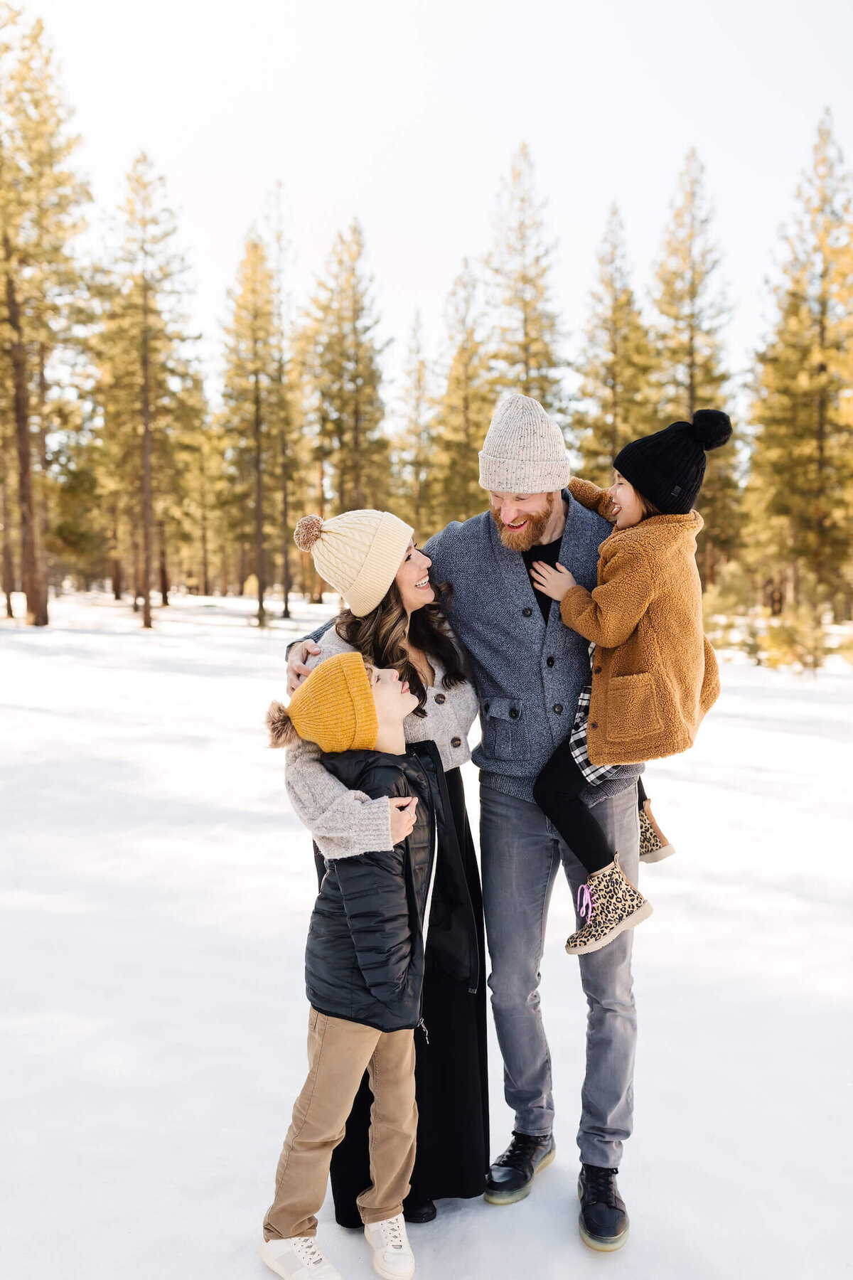 bend-family-photographer-family-on-sunriver-vacation-walking-in-snow