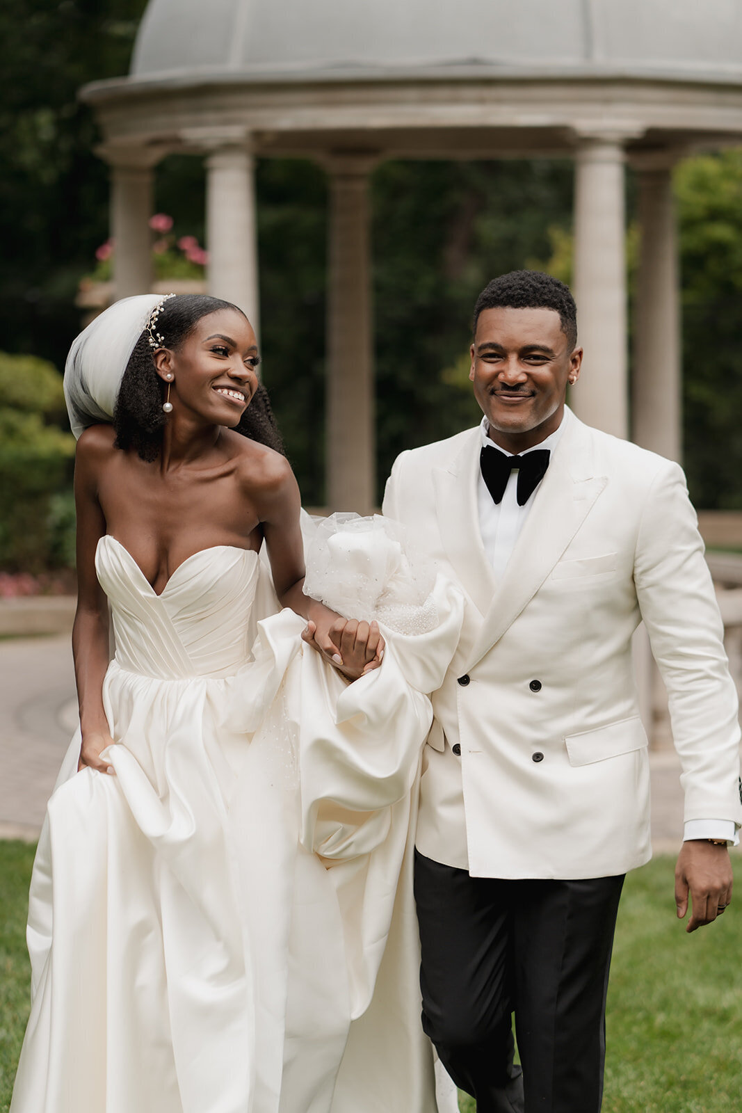 happy smiling black bride and groom holding hands walking outside