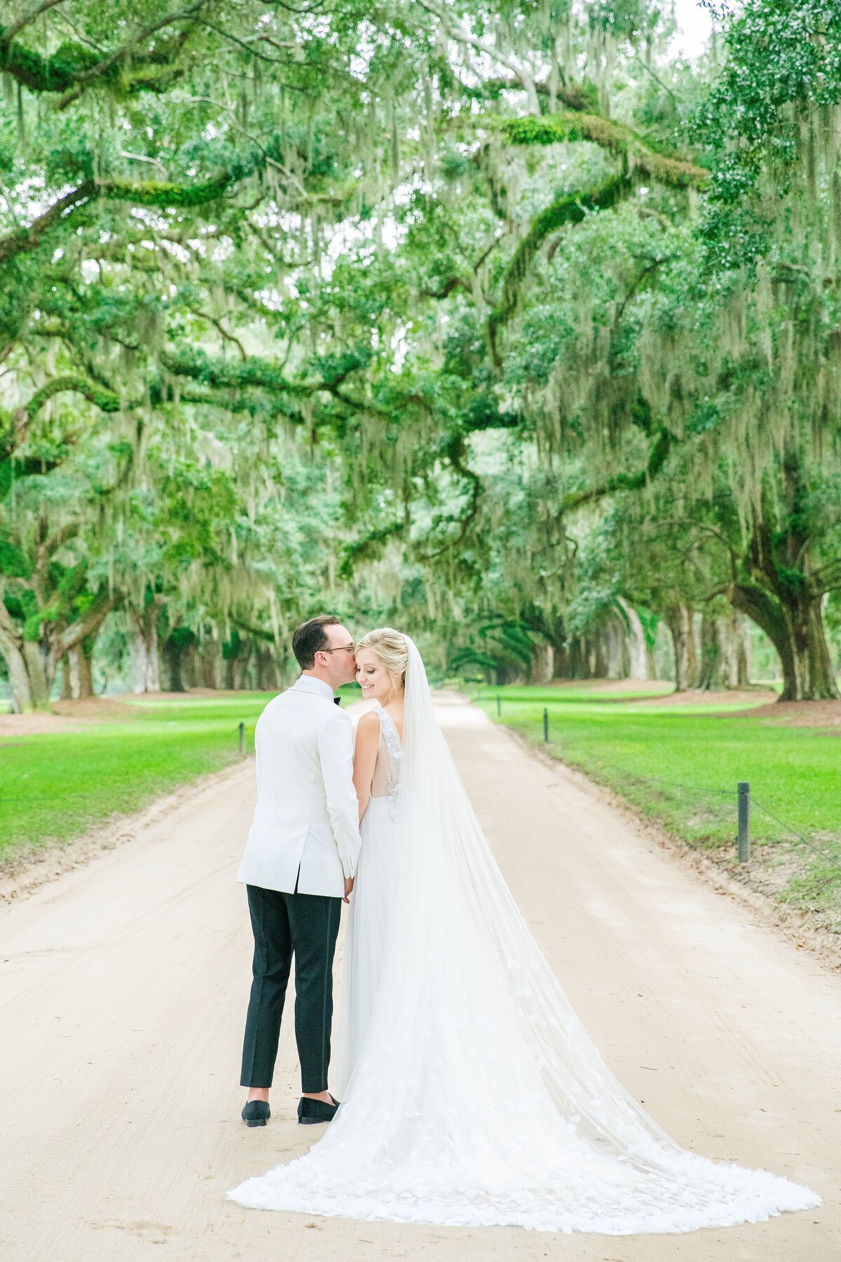 couple on avenue of oaks at boone hall plantation wedding