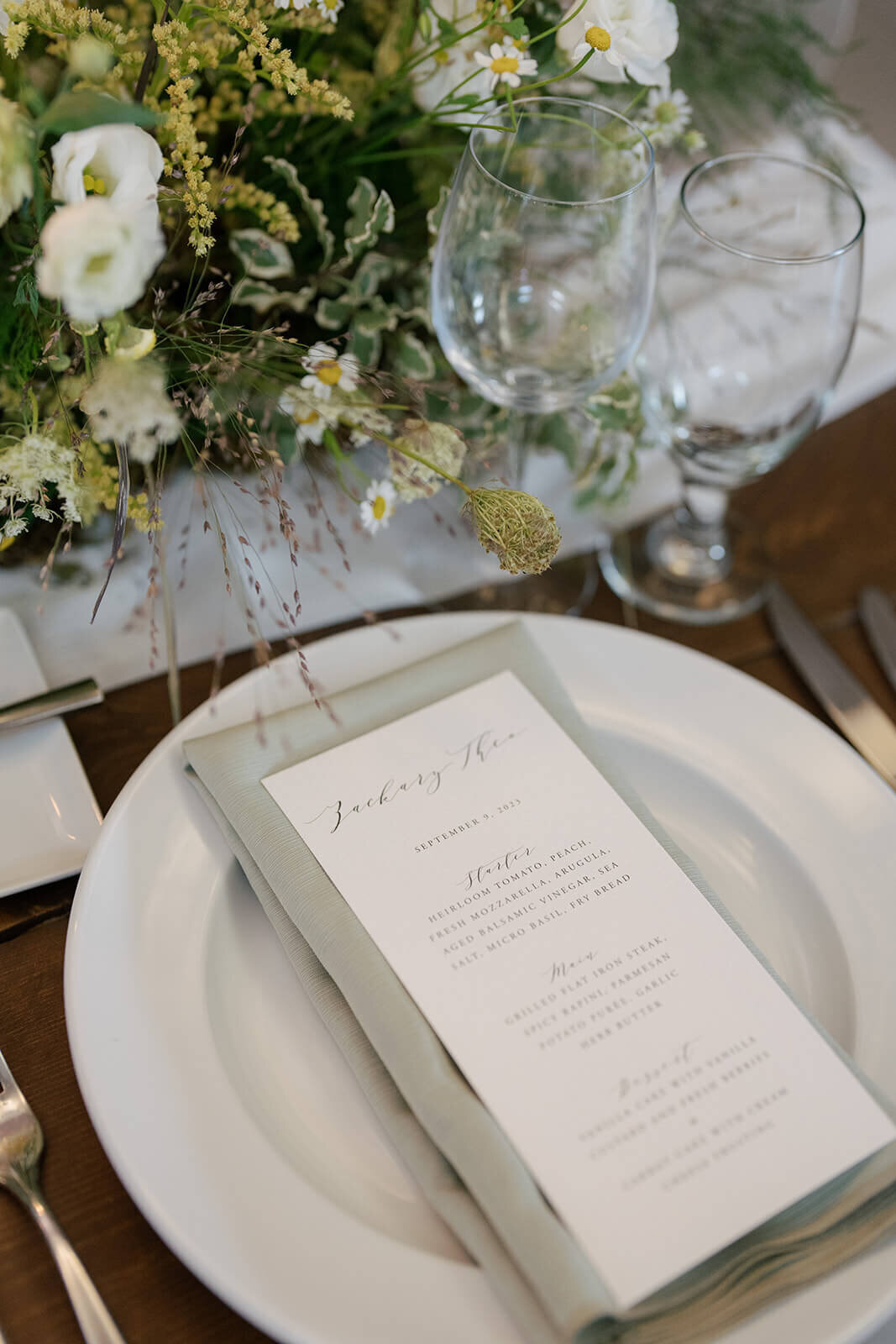 Wedding reception table at Aspen Meadows Resort, featuring an elegant menu card and detailed place settings.