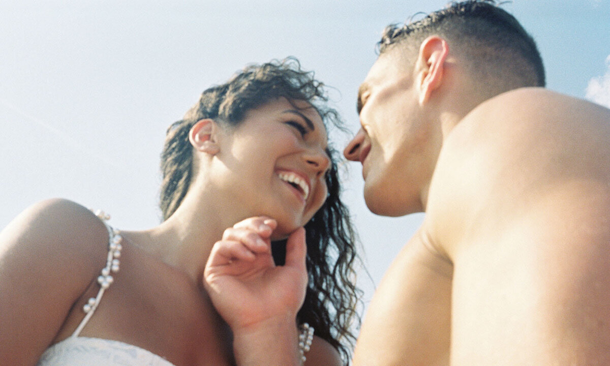 Engaged couple kisses each other at NC Museum of Art
