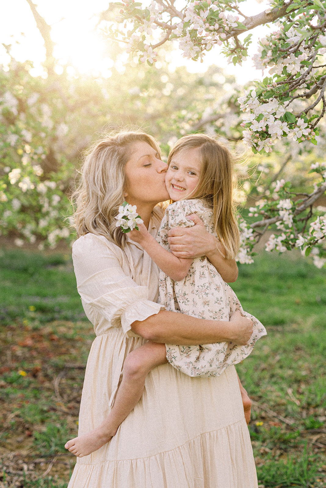 Mom kissing young daughter