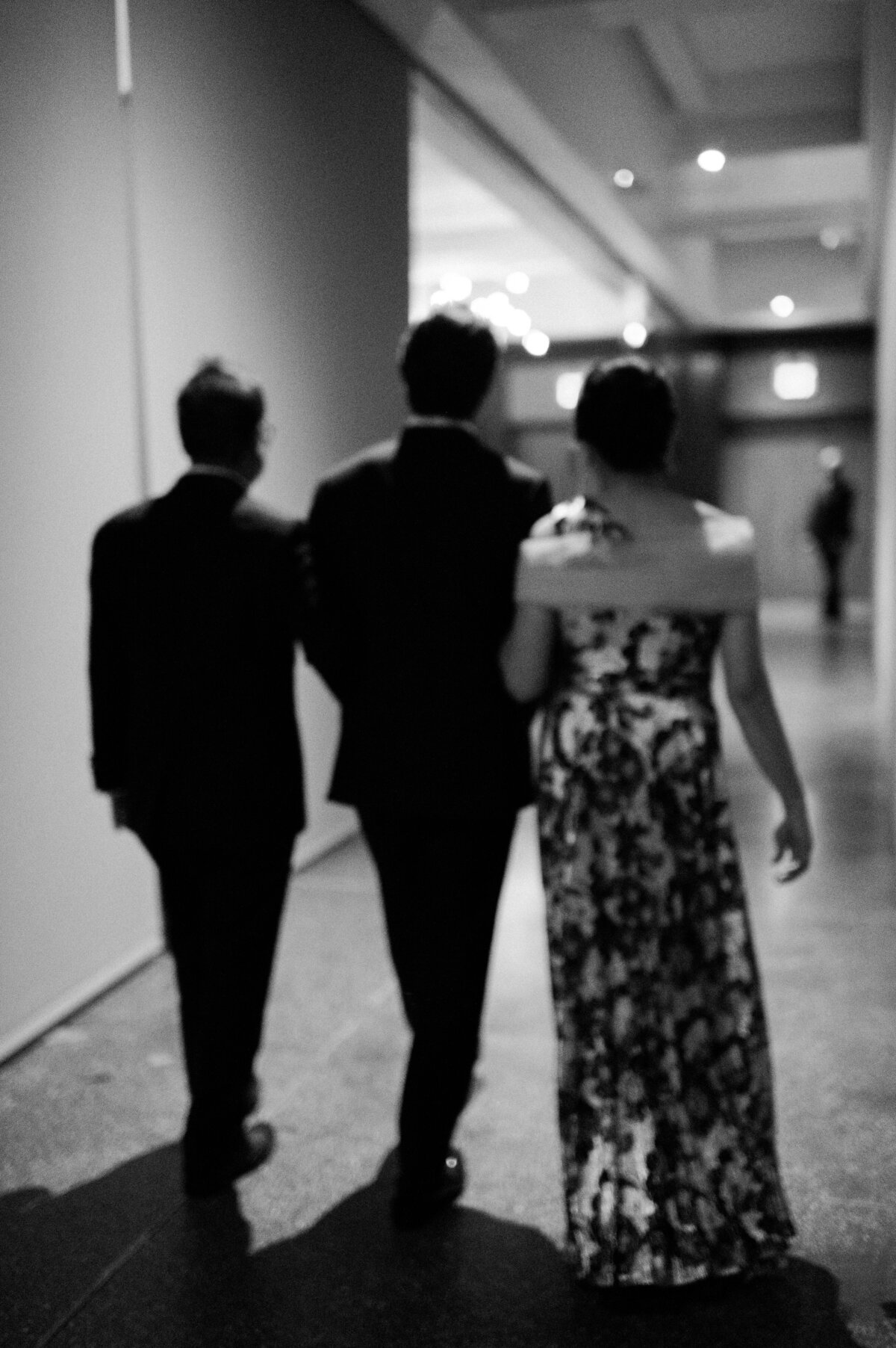 Groom and family walk down a hallway