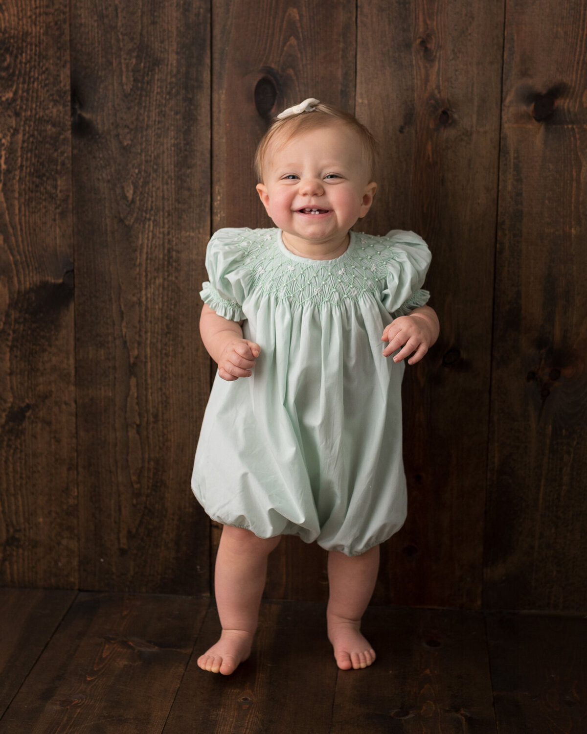 standing baby portrait in green dress by Laura King, Houston Photographer