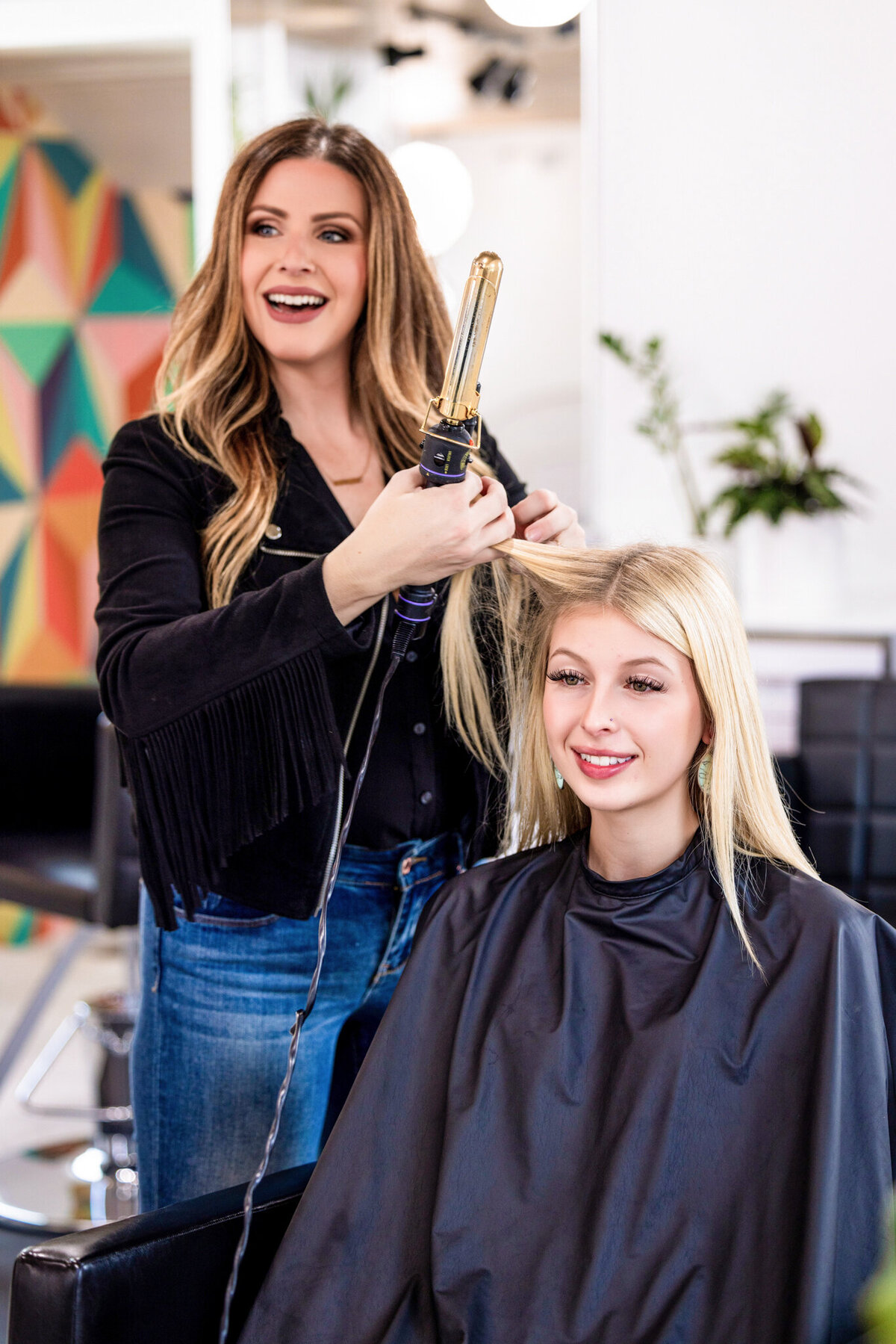 A sleek, editorial-style portrait capturing the personality and professionalism of a top stylist at 808 Mane.