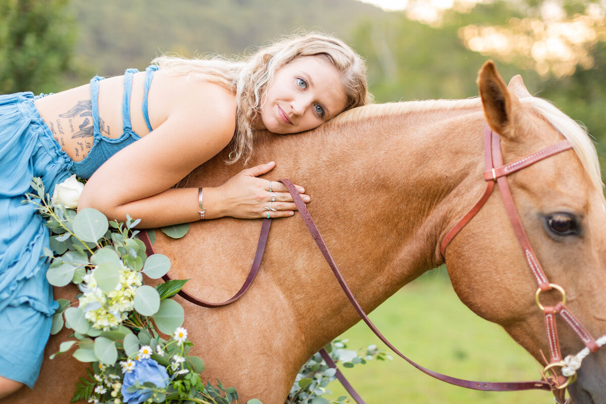 Girl in blue poses with horse by Tiffany McFalls.