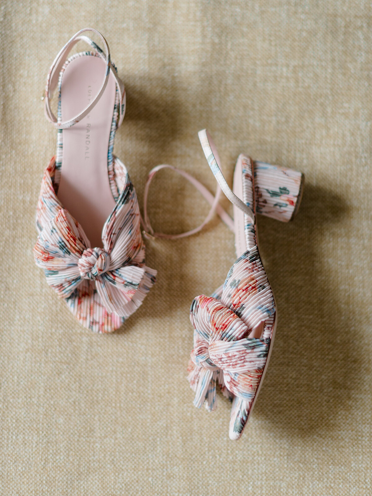 Flatlay of floral block heels by Loeffler Randall, styled for a romantic editorial at Cairnwood Estate. Captured by Elizabeth Kane Photography—Philadelphia Fine Art Wedding Photographer—these statement bridal shoes add a whimsical, fashion-forward touch to any luxury wedding look. Perfect inspiration for East Coast brides seeking refined yet playful details.