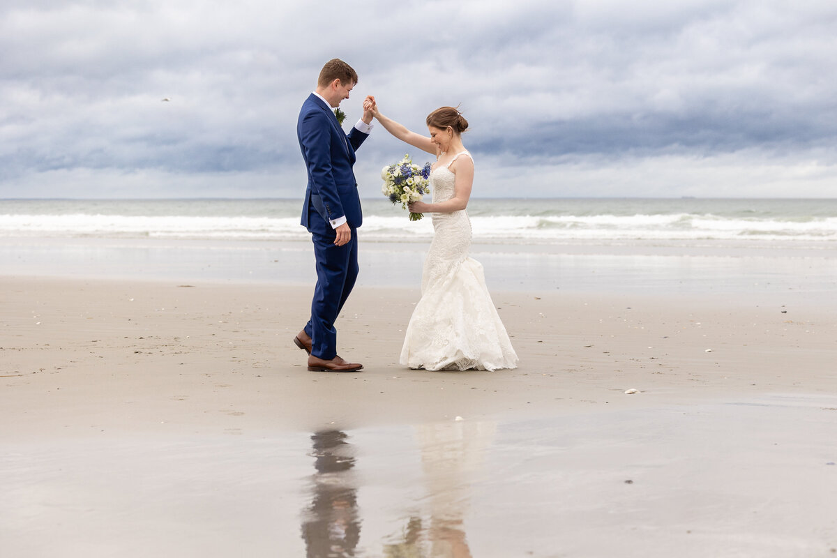 coastal-first-look-couple-dances-on-beach-relection-lisa-gilbert-photography