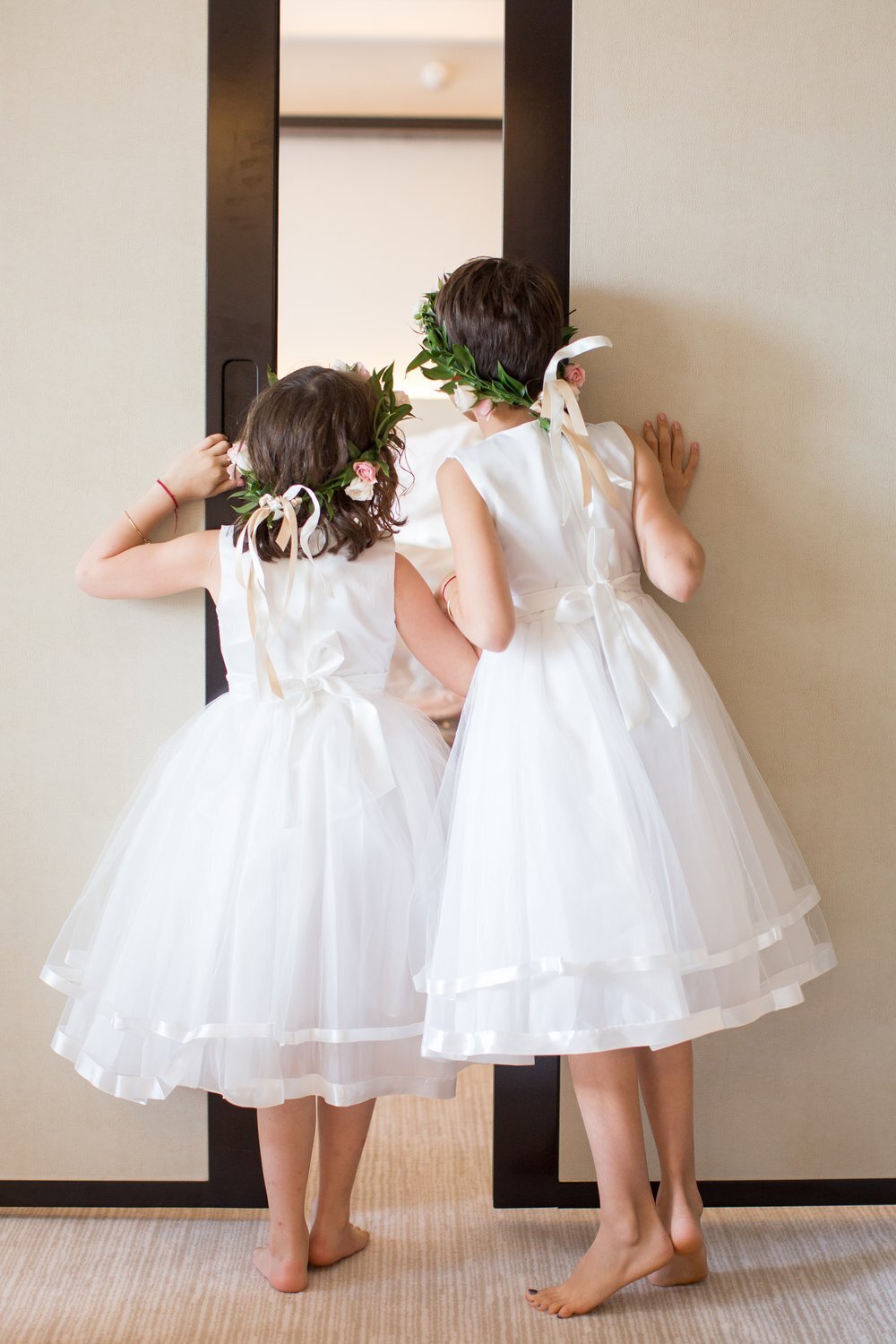 Flower girls peeking in at the bride during a wedding at the Penisula Hotel in Chicago