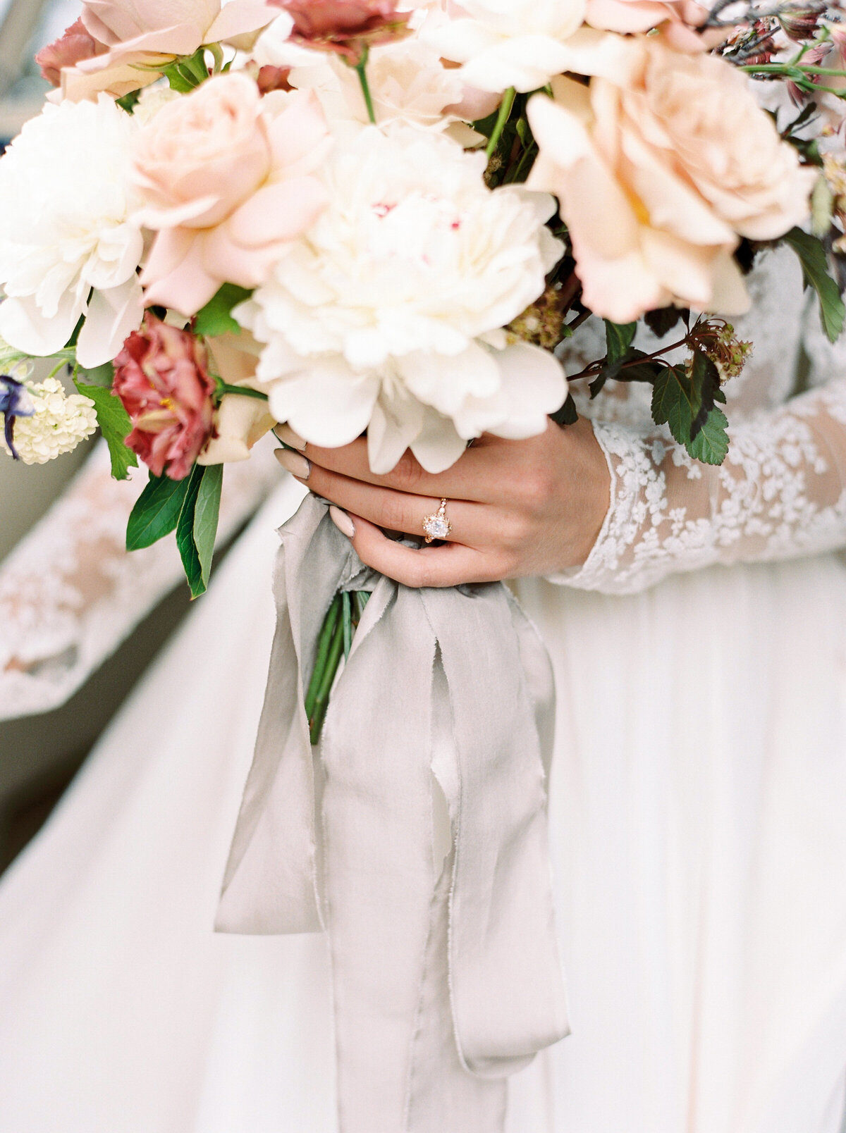 Bride holding a bouquet with both of her hands.