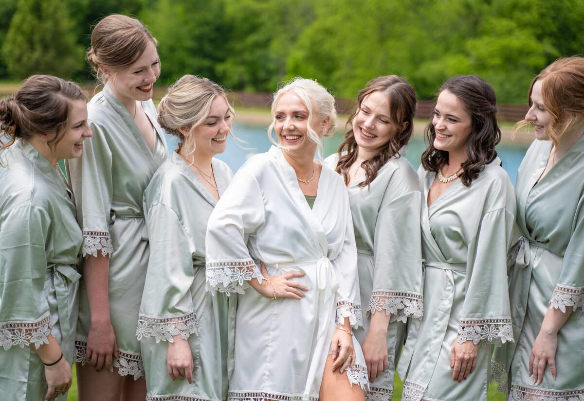 The bride, Jessica Cox, and her bridesmaids laughing in their robes at Jessica's wedding at Peacock Ridge in Lawrence, Ohio.