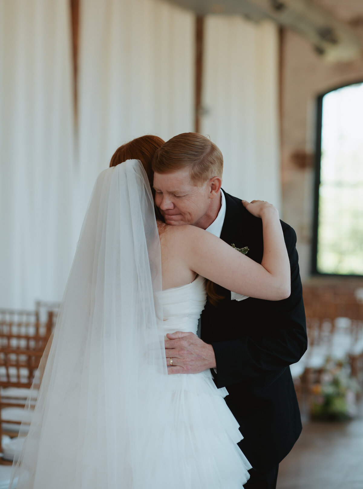 bride having first look with her father in the ceremony space