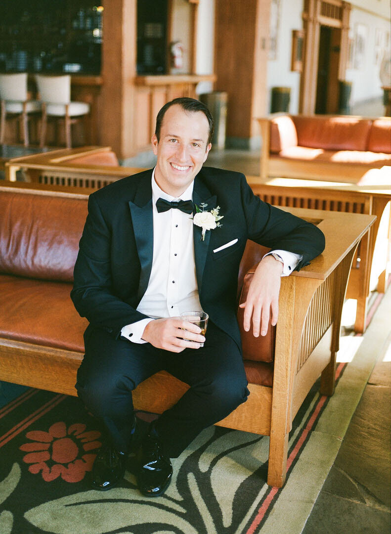 Groom Holding Drink Smiling at Camera Photo