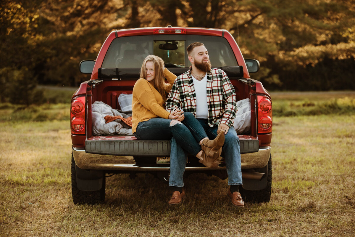A couple's portrait with a vintage truck, adding a touch of rustic charm to their love story.