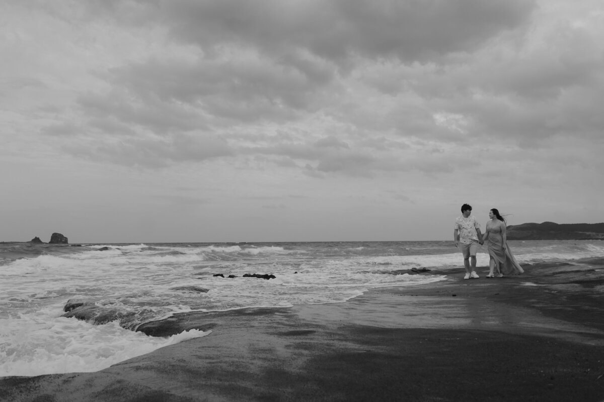 the couple walking hand in hand in Gwangchigi Beach of jeju island