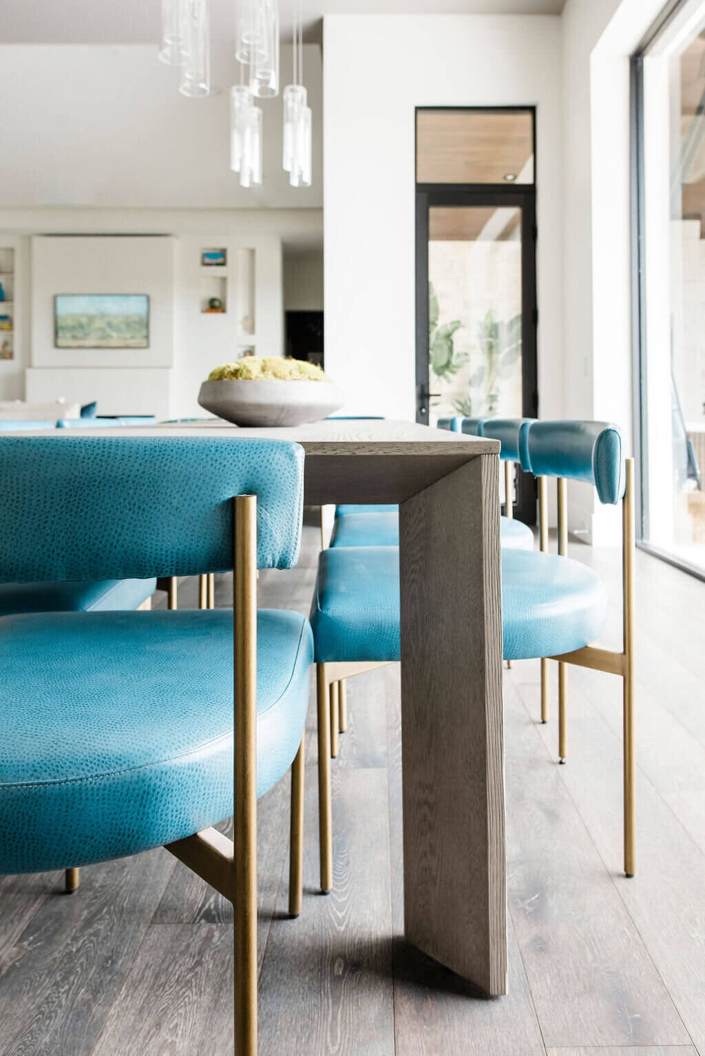 oyster creek studios austin barton creek turquoise leather dining room chairs around a table in dining room
