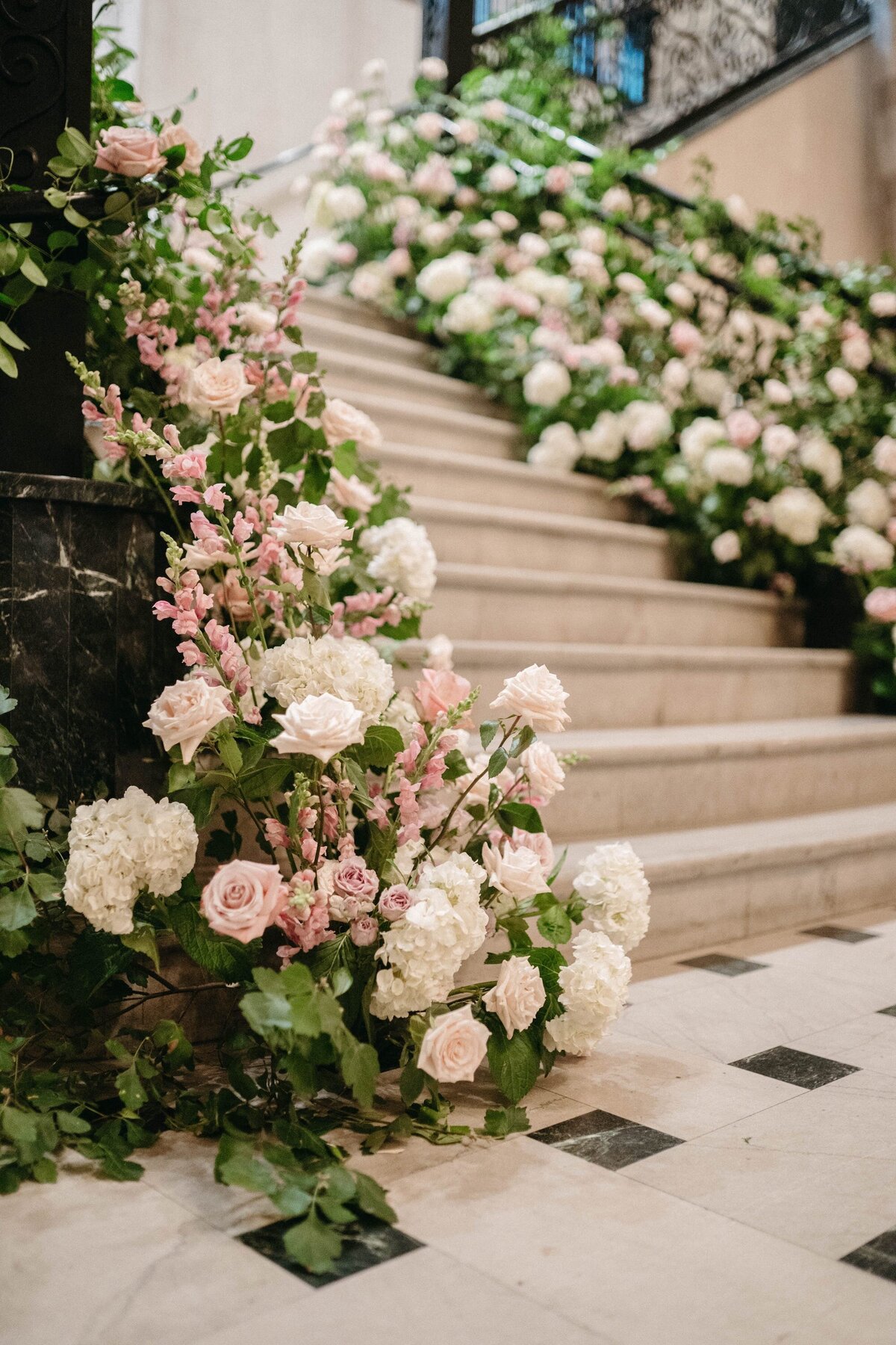 A large floral arrangement cascading up stairs at the Mayo Hotel in Tulsa.