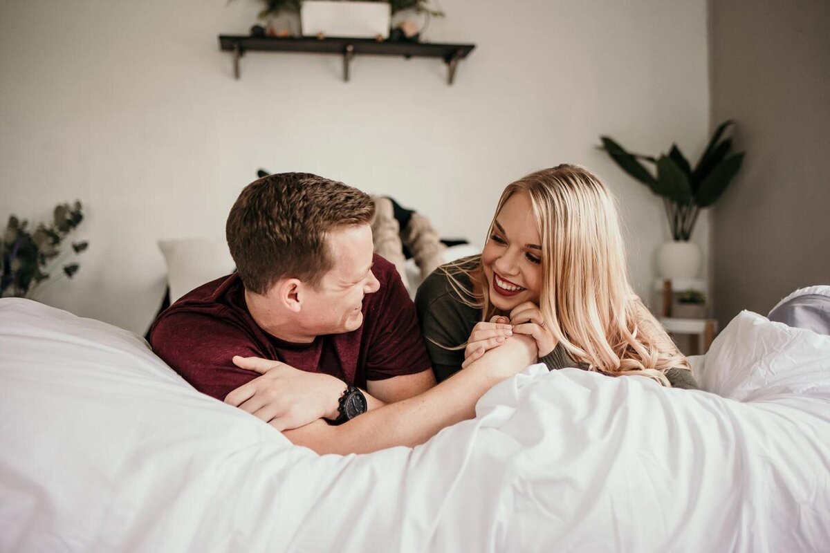 happy-couple-home-in-bed