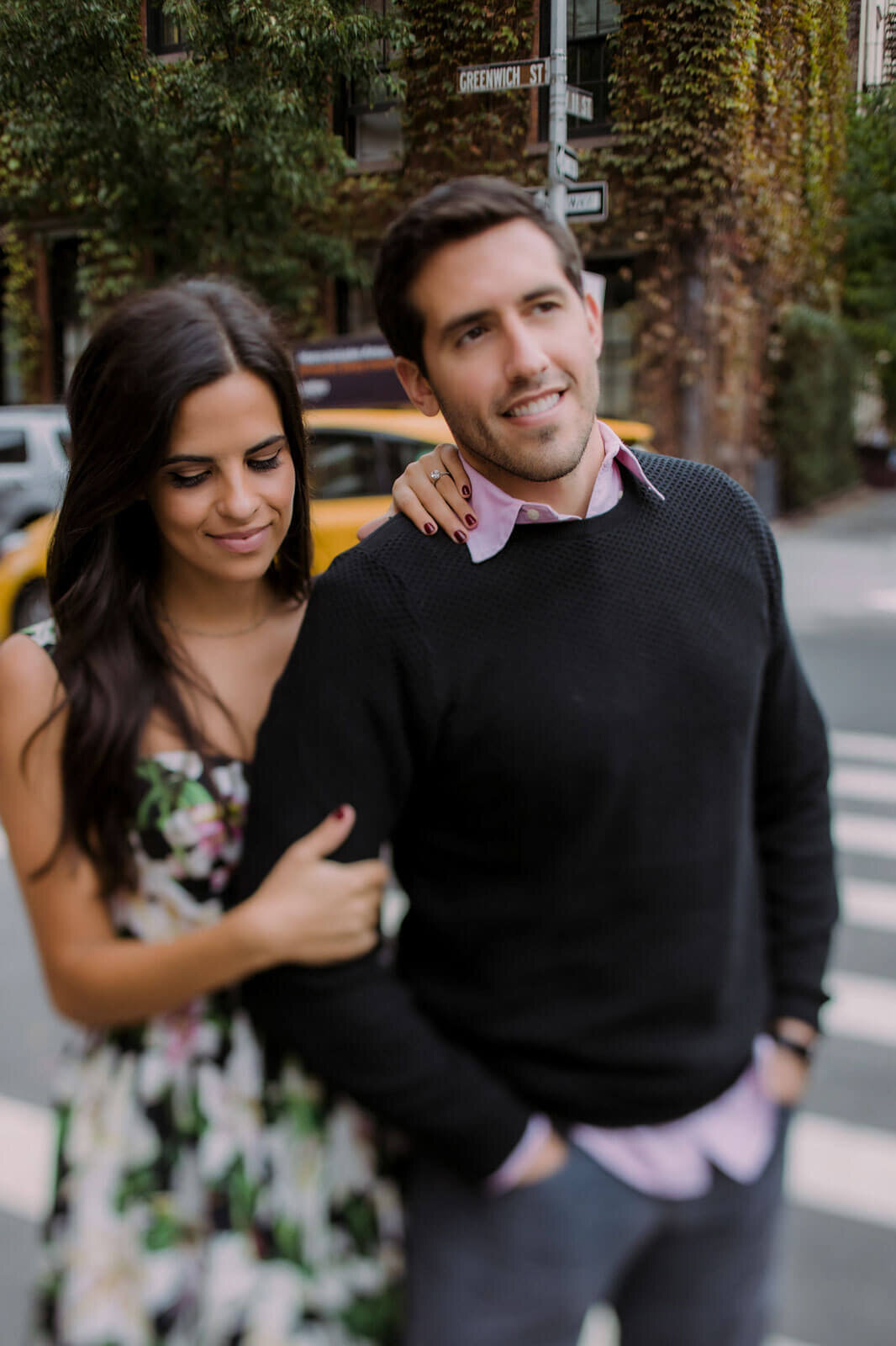 The engaged couple is at West Village, Manhattan, NYC, with an ivy-covered building in the background. Image by Jenny Fu Studio.