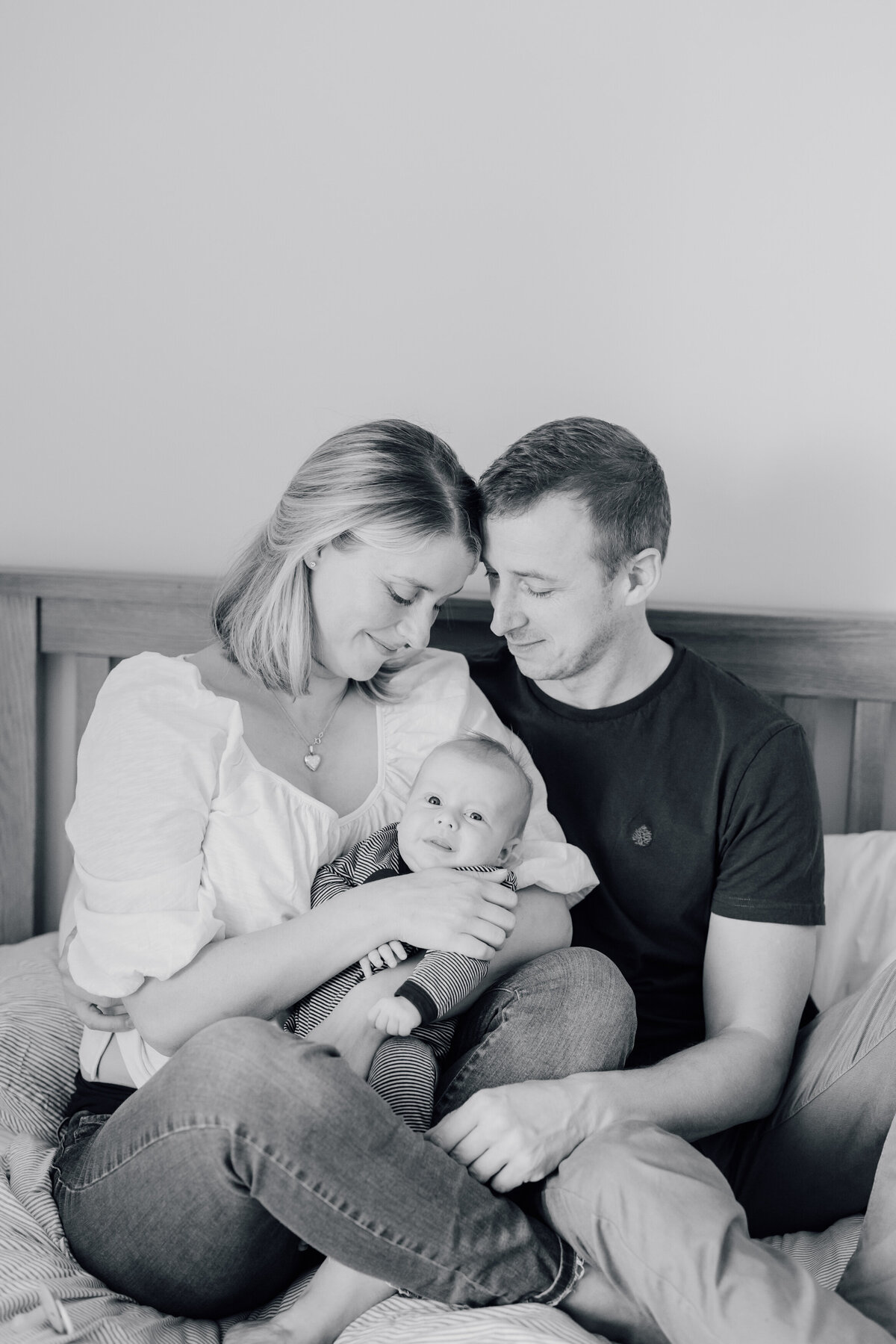 mum-and-dad-with-newborn-baby-on-bed