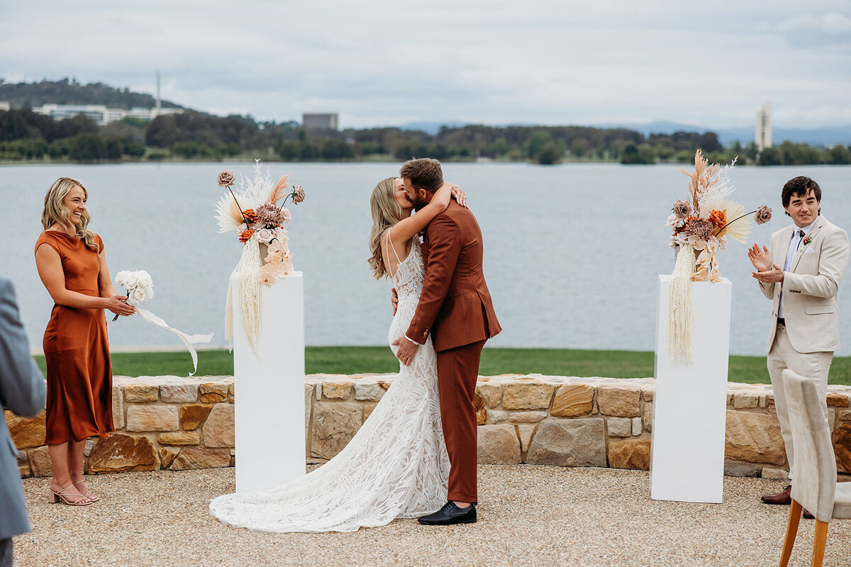 First kiss as husband and wife! Lake Burley Griffin in the background