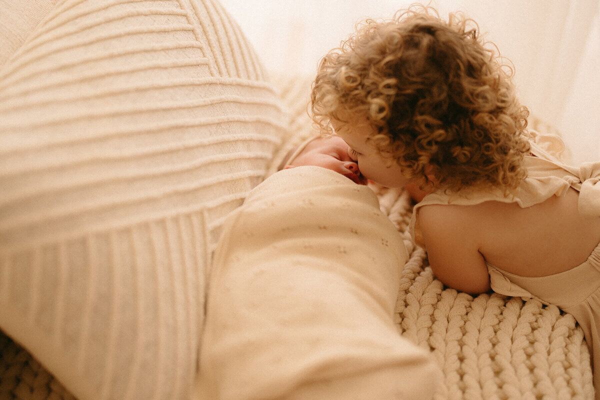 Close-up detail of tiny newborn hands during Nashville studio session with big sister