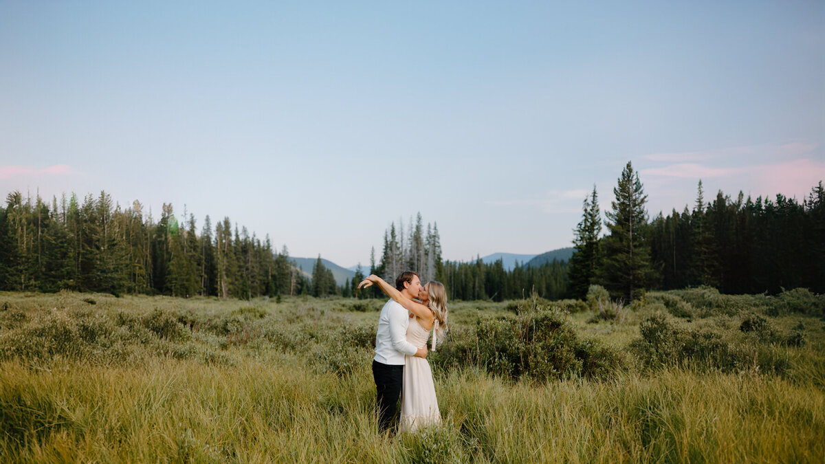 An engaged couple sharing a romantic kiss at Guanella Pass in Colorado during their engagement session.