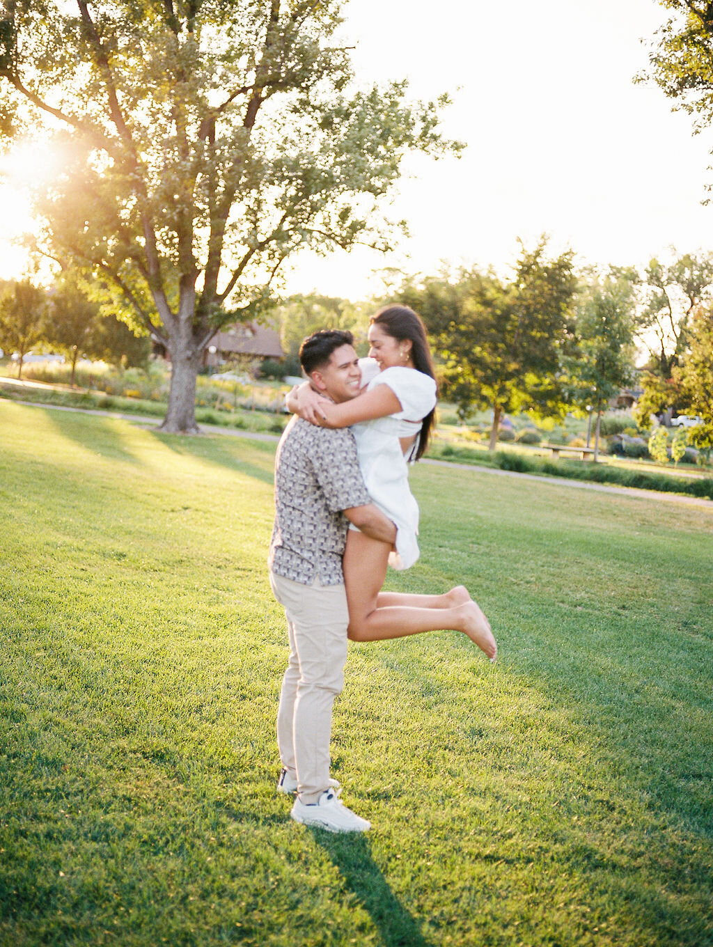 Film engagement photography in Denver, Colorado on a summer evening at Washington Park.