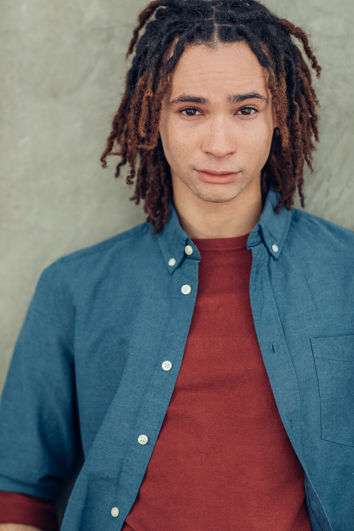 Young Man Wearing Blue Button Down Polo with Inner Maroon Sweater Headshot in LA