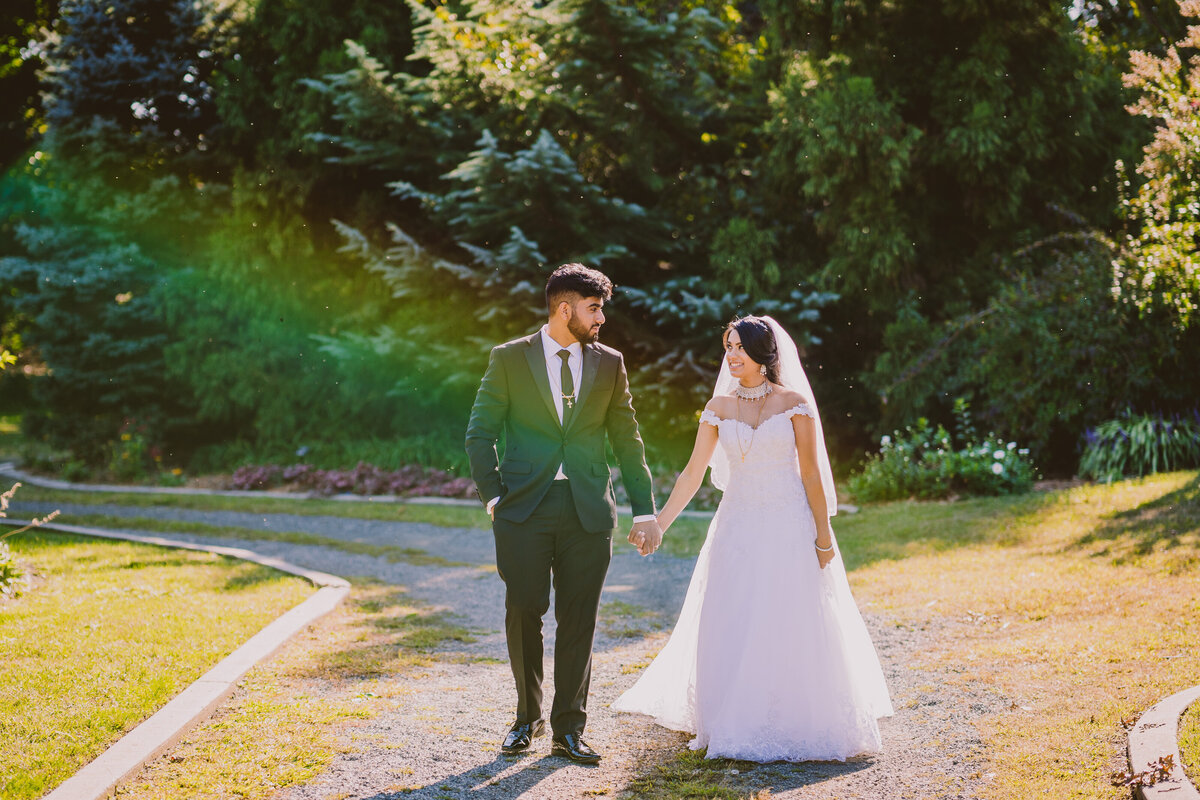 indian christian bride and groom walking together after the wedding ceremony at the centennial gardens in floral park ny