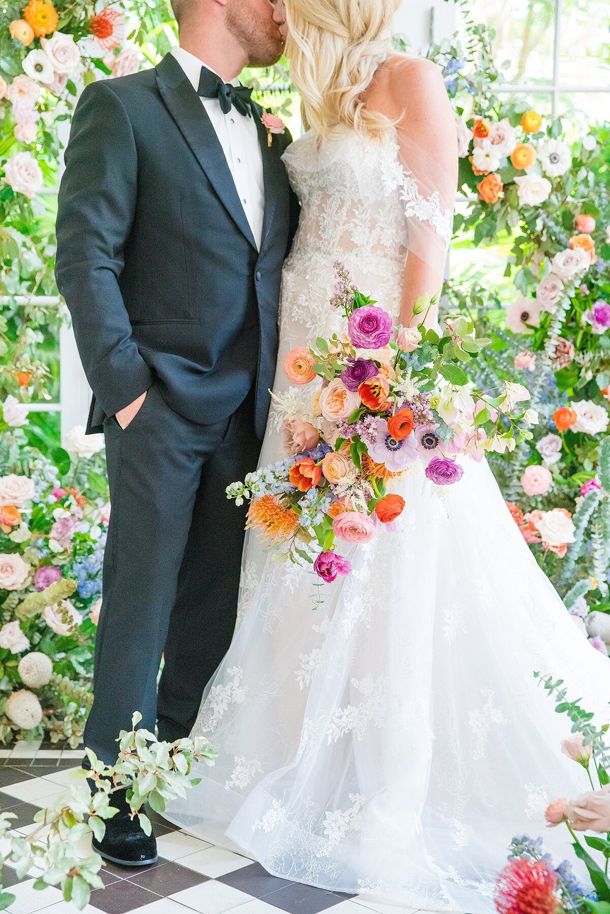 bride + groom attire with bright vibrant florals