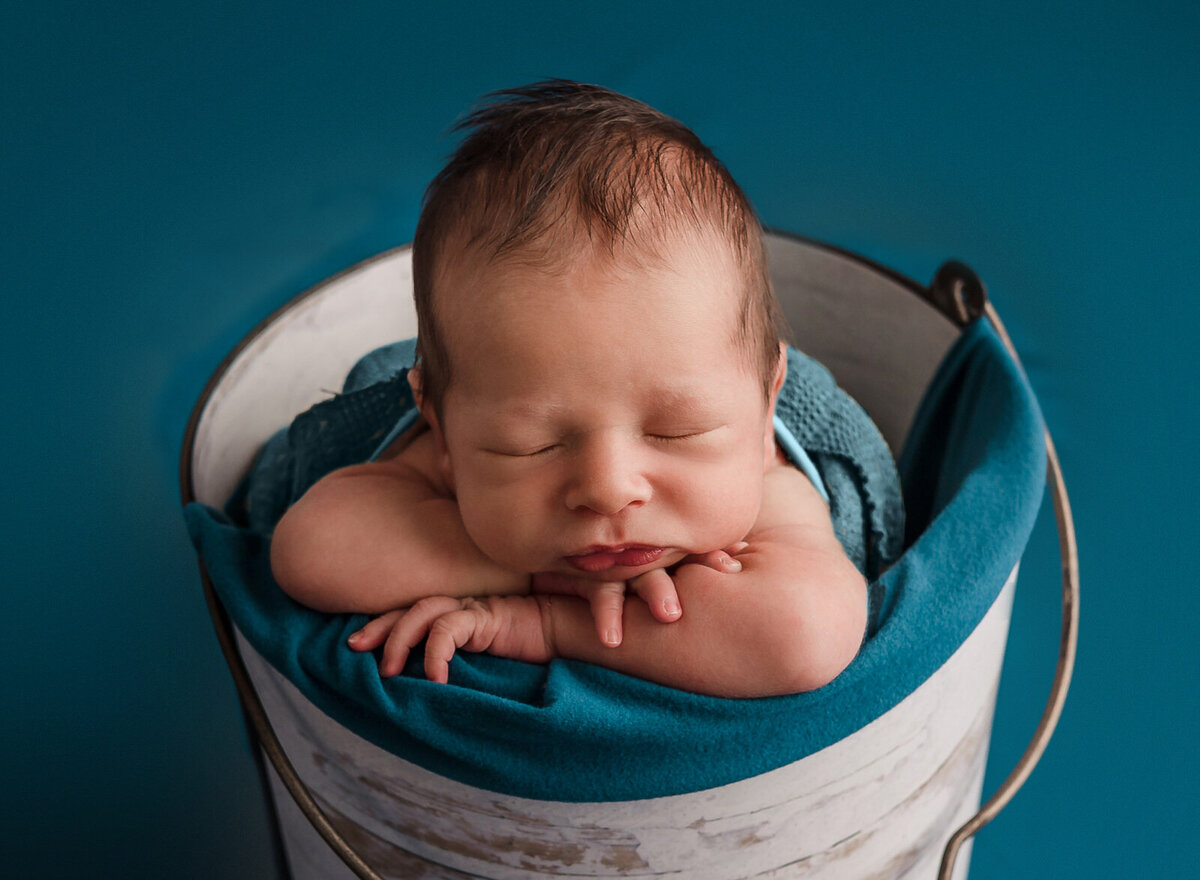 newborn-baby-boy-posed-in-bucket