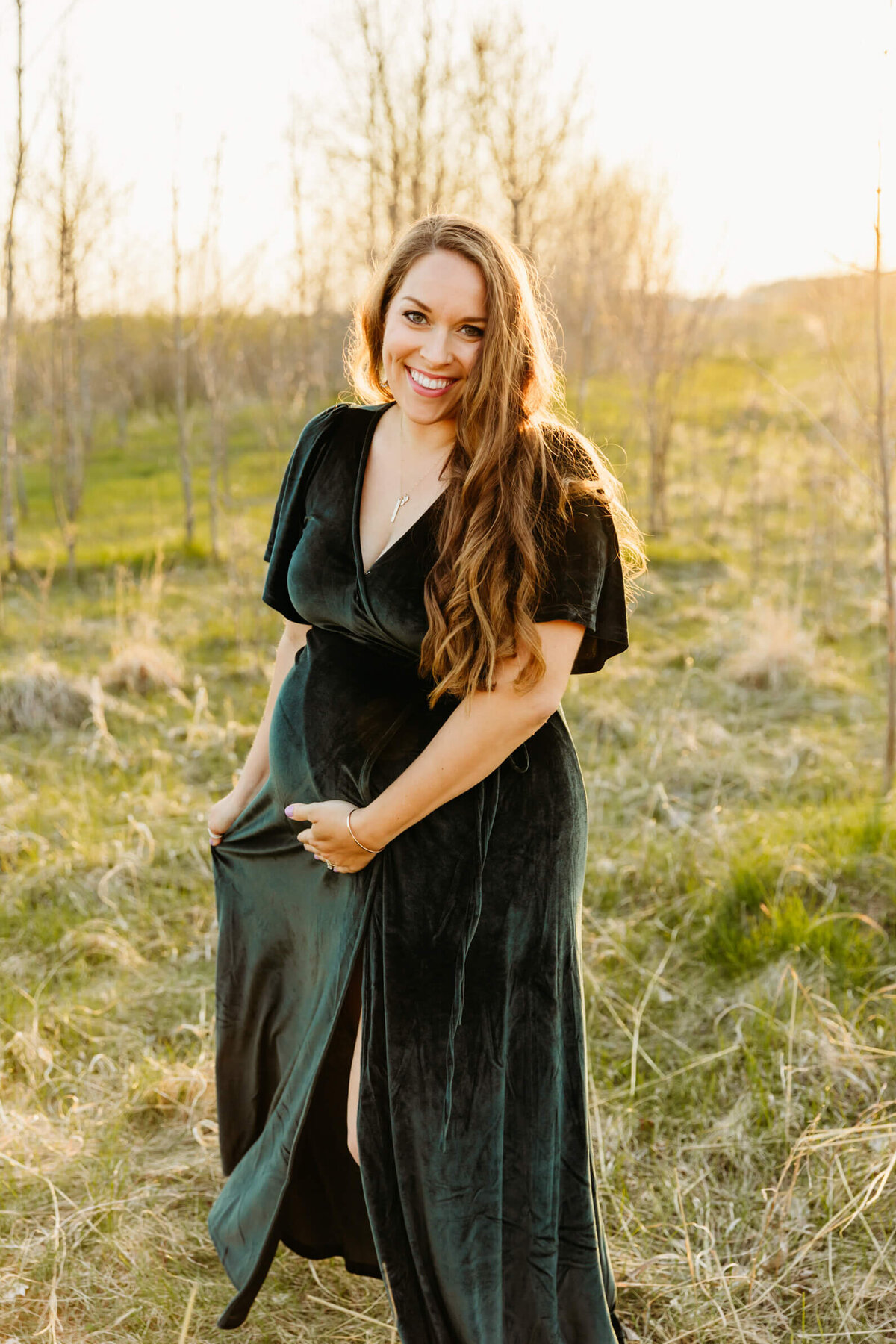 gorgeous expecting mom playing with her dress during her Green Bay maternity photo session