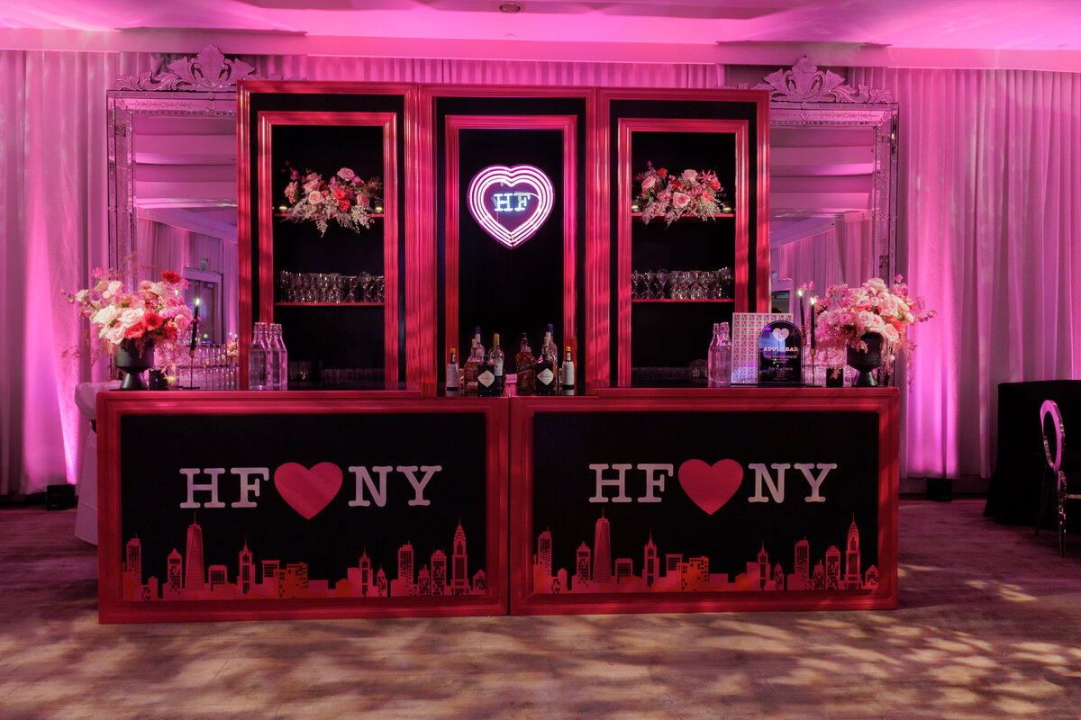 A bar area decorated in pink and black