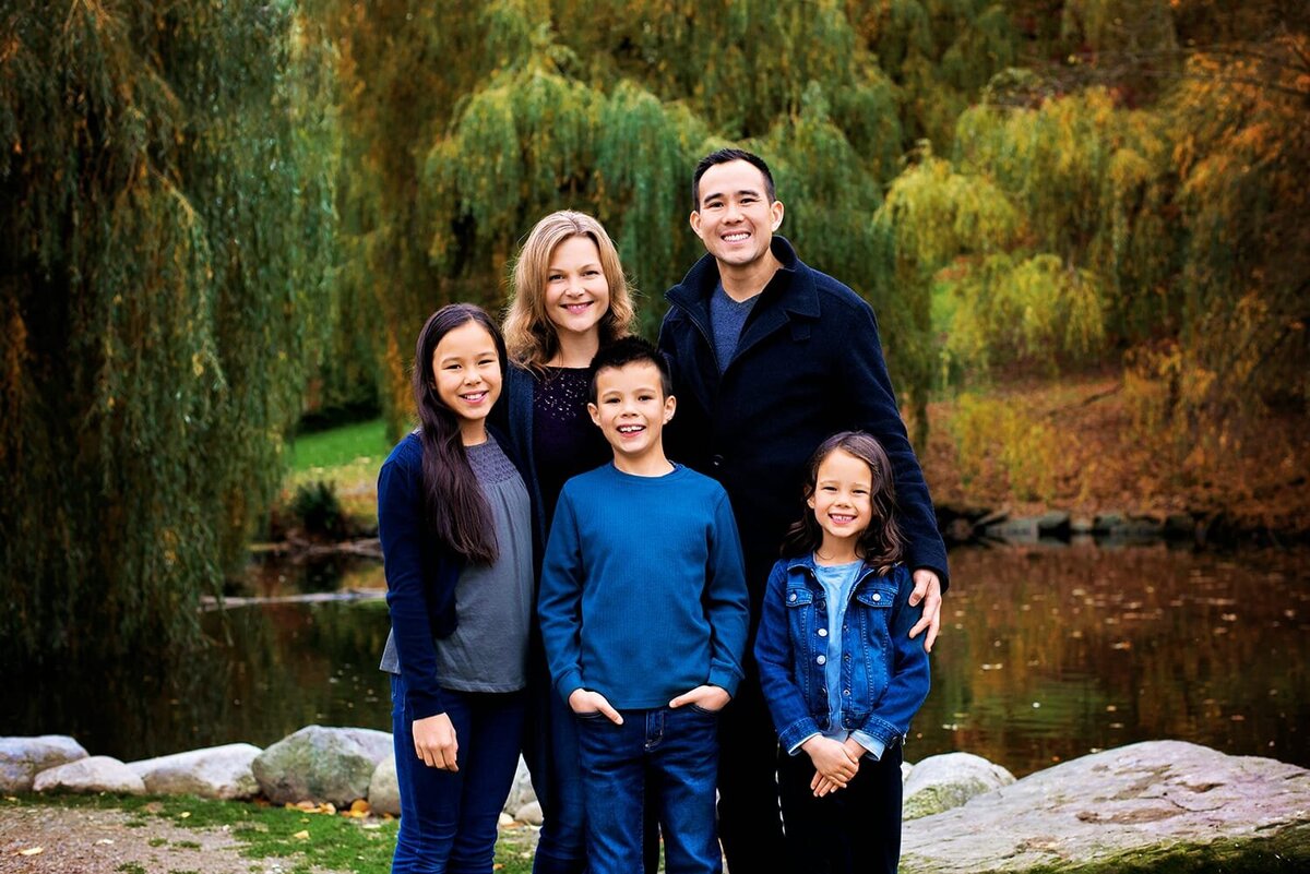 Classic family photos with father, mother and 3 kids outdoors at a duck pond