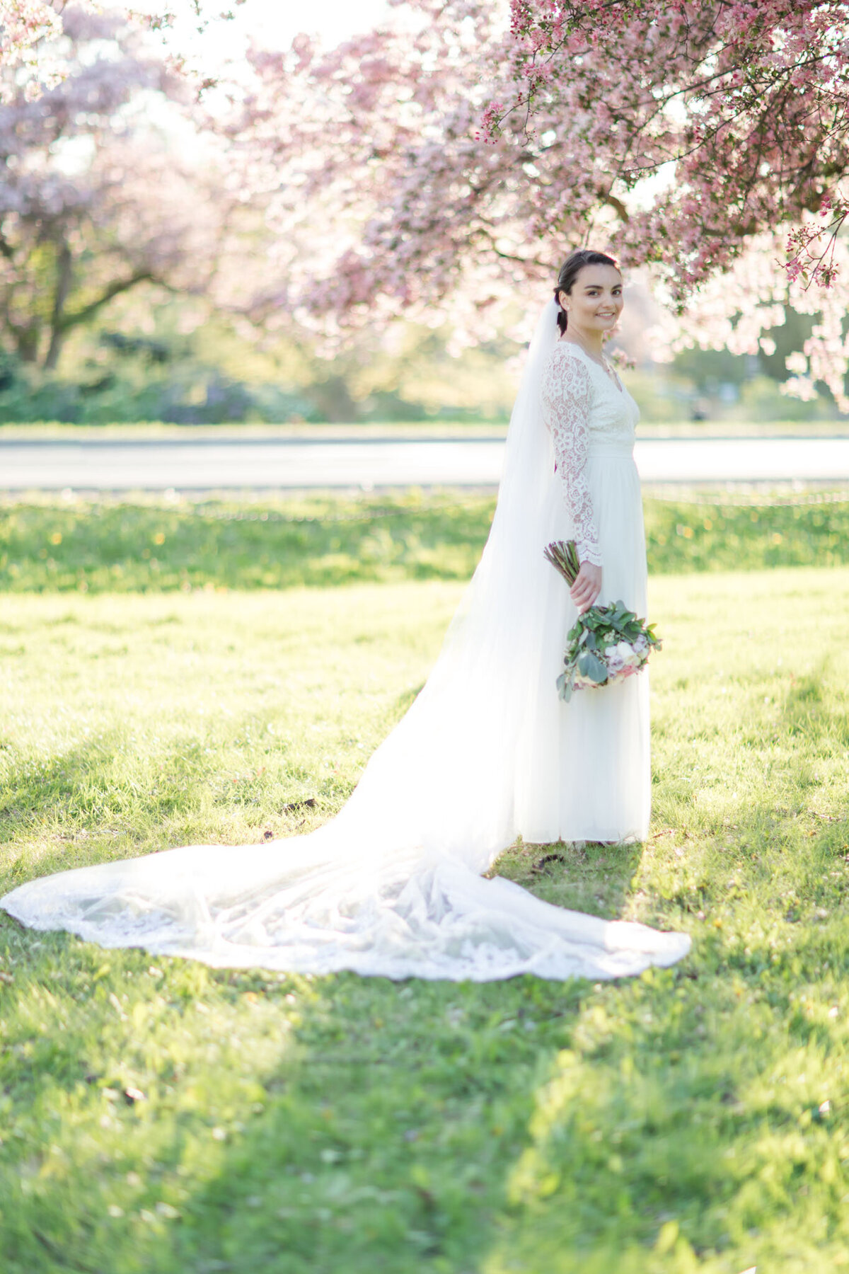 Step into the enchanting world of bridal elegance with Taylor's portrait, captured amidst the blossoming beauty of Ottawa's Dominion Arboretum by the skilled lens of Ottawa Wedding Photographer, Lauren Duffy. Draped in a timeless wedding dress and cathedral-length veil, Taylor radiates grace against the ethereal backdrop of cherry blossoms. Lauren Duffy Photography intricately frames this moment, blending the allure of nature and the sophistication of bridal elegance. Immerse yourself in the artistry that defines Ottawa weddings with Lauren Duffy Photography, your premier choice for capturing love stories amidst the scenic splendor of the nation's capital.