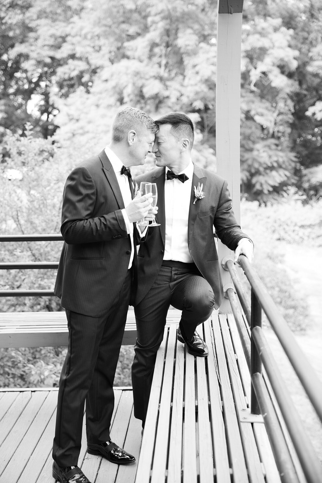 Two grooms enjoy a champagne toast
