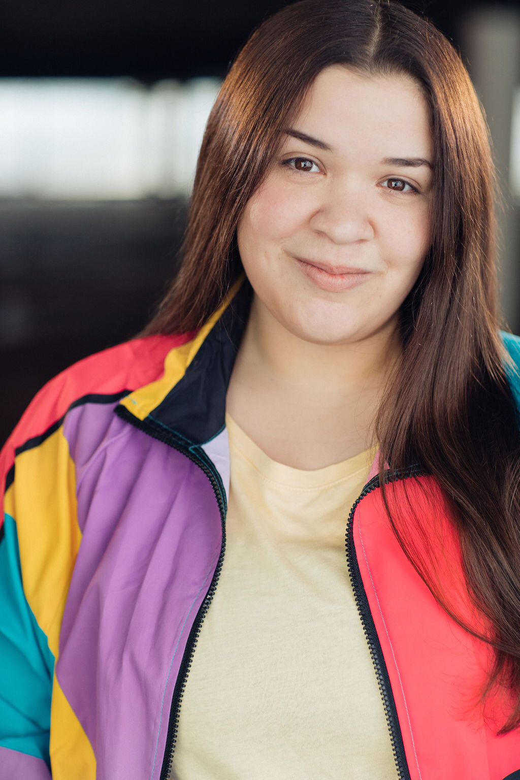Headshot Photograph Of Young Woman In Colorful jacket And Inner Yellow Shirt Los Angeles