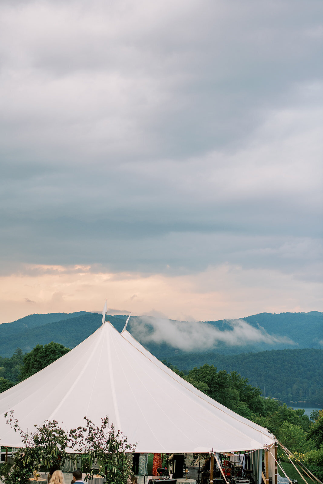 Sailcloth reception tent overlooking foggy mountain views at a Cashiers, NC wedding.