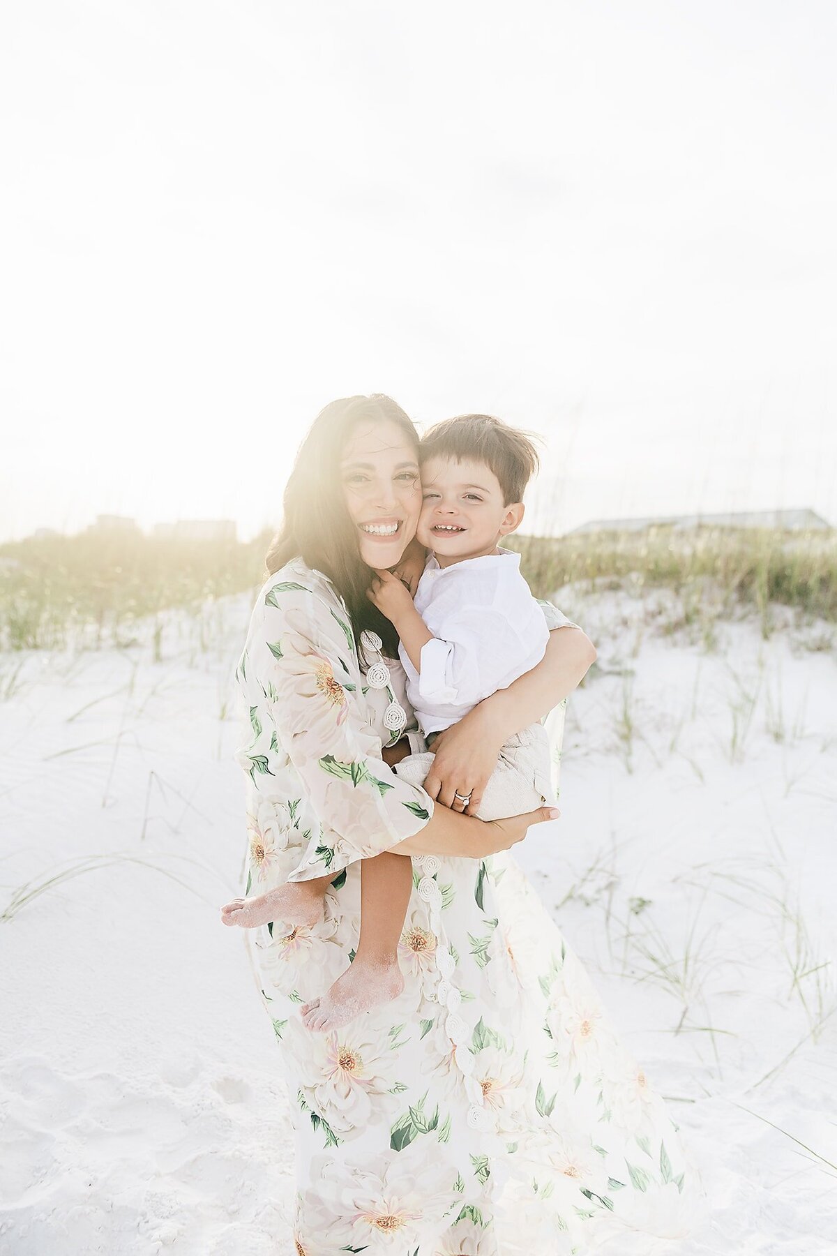 a mom holding her  boy on the destin beach