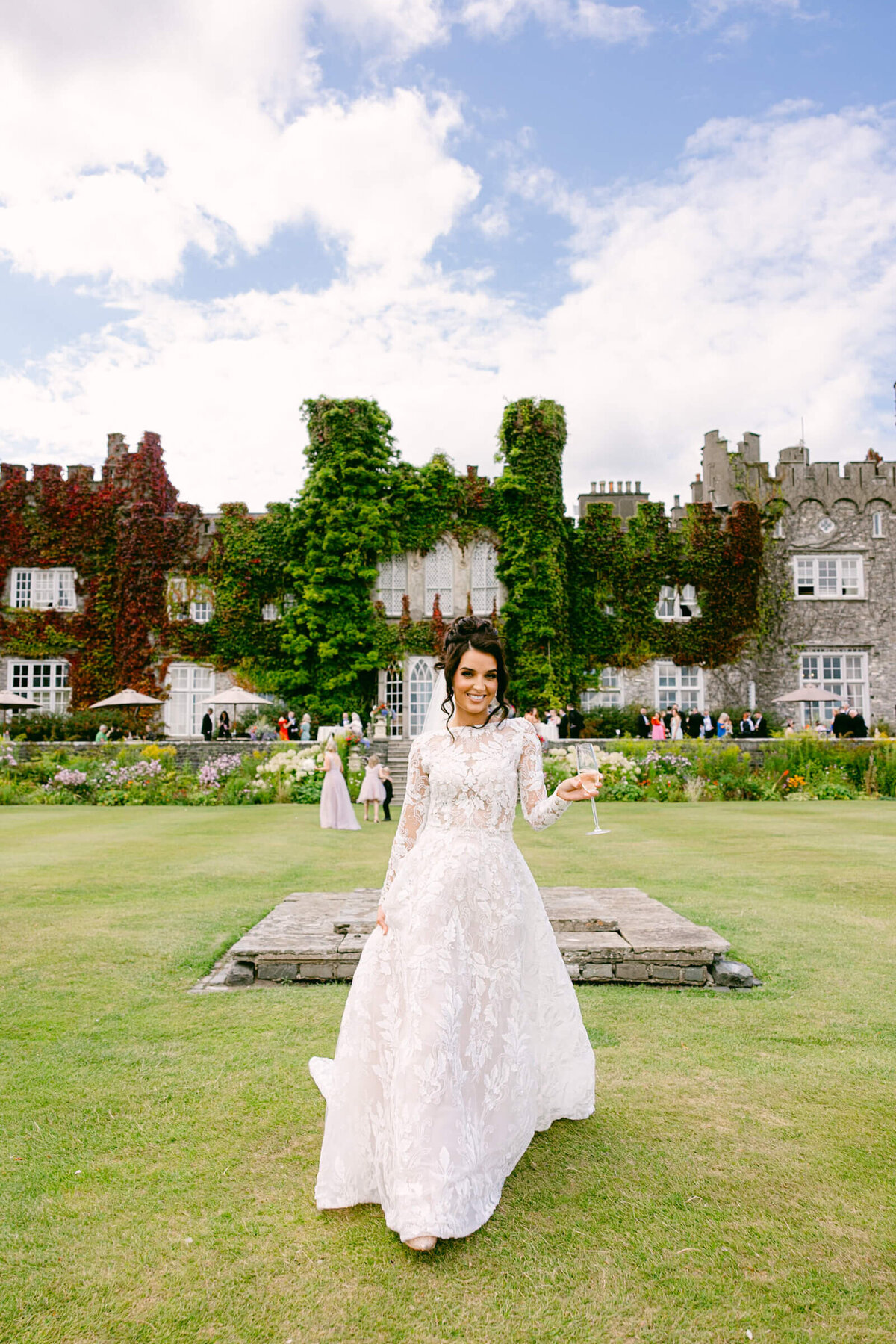 A wedding photo of the bride in her white dress with Luttrellstown Castle in the background