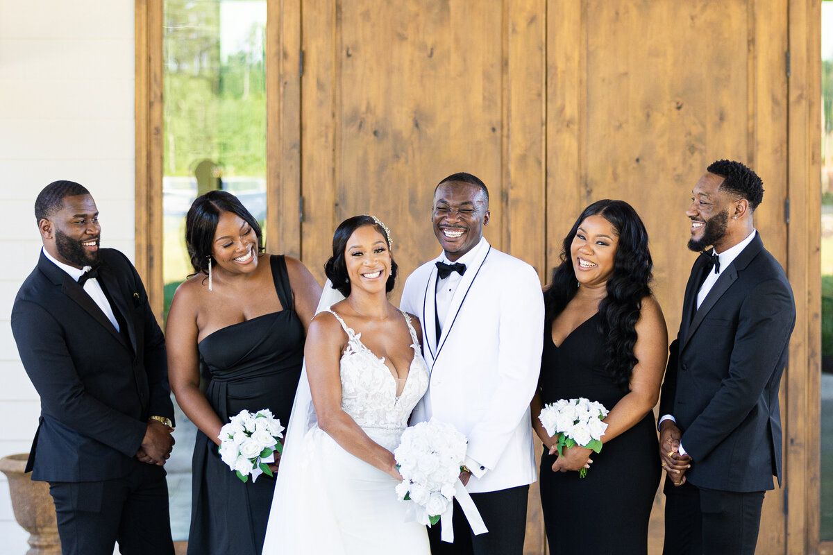 Black bride and groom and wedding party in a line