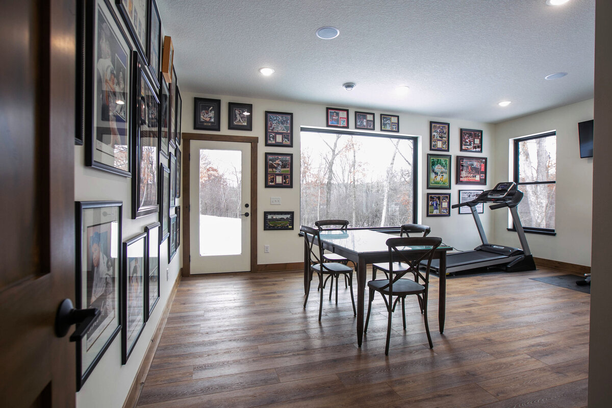 Open Concept Custom Home in Elk River Minnesota eat in kitchen with wood floors and neutral tones by Cornerstone Custom Builds