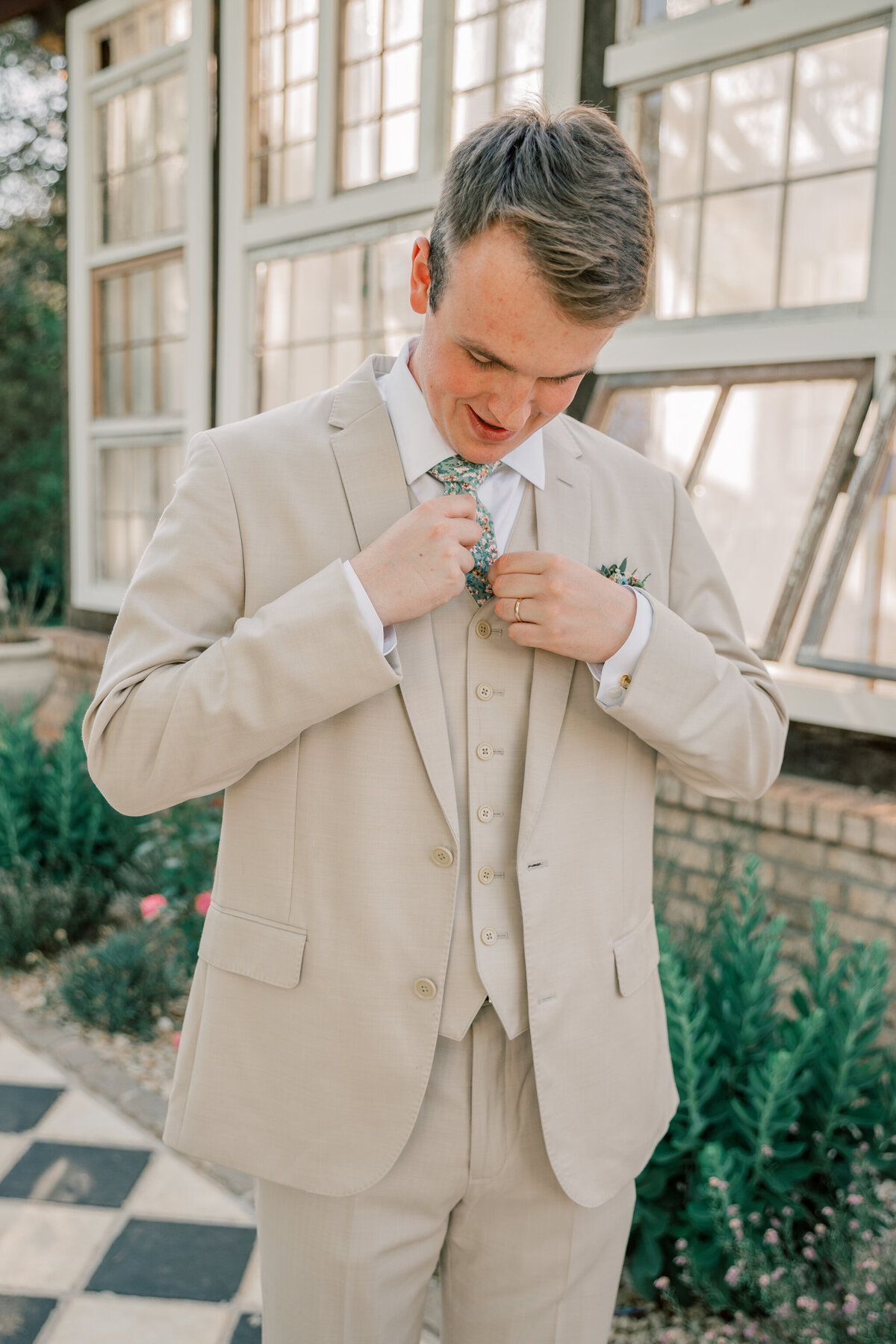 Three Oaks Manor Wedding | groom adjusts his tie