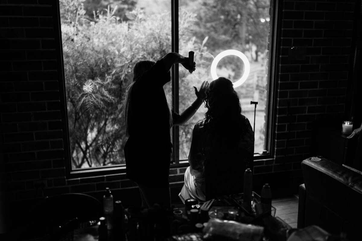 Capture the timeless elegance of a bride's intimate pre-wedding moments with our stunning black and white photography."