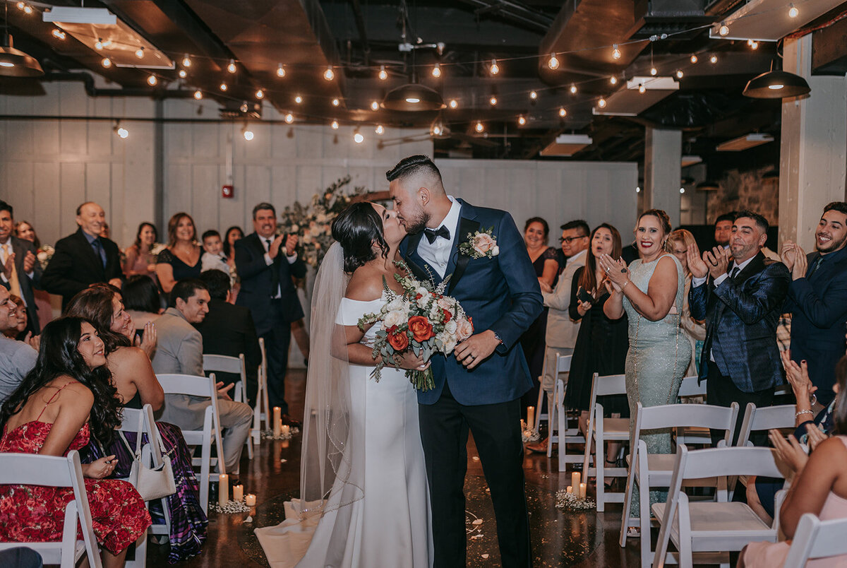 Couples kiss at the aisle