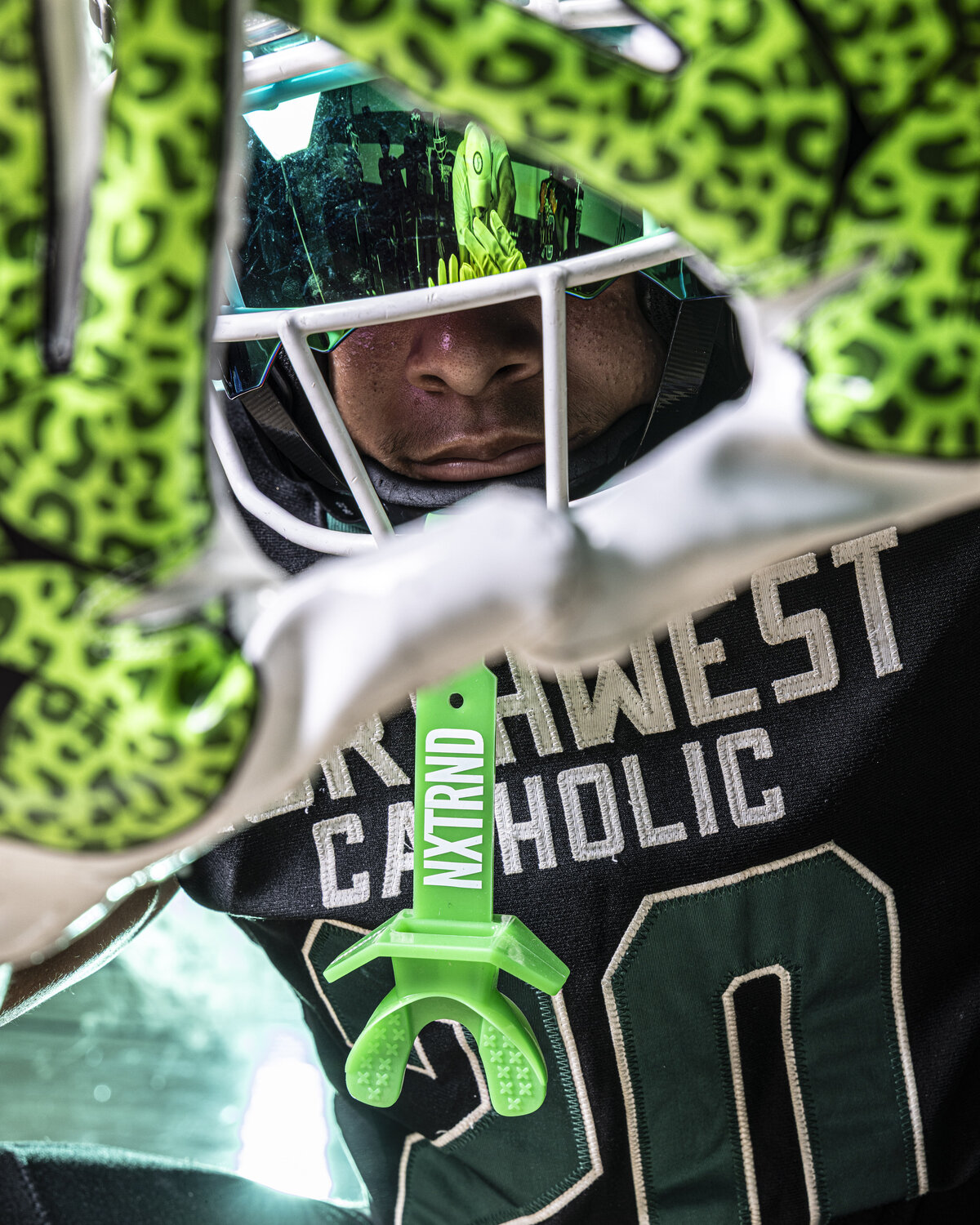 CT Photographer | Media Day Photos | Football Player posing with receiver gloves in front of his face. Closeup photos