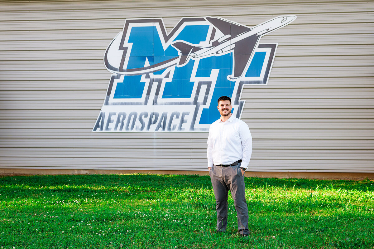 MTSU Senior standing at aerospace mural